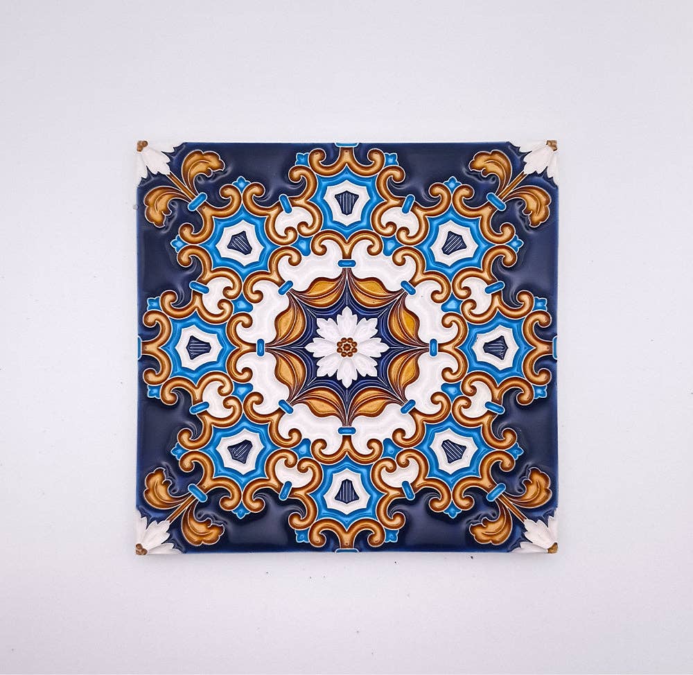 The Tejo Shop Decorative Drop Ceiling Tiles showcase an intricate, symmetrical pattern in blue, white, and gold on a dark background, inspired by traditional Portuguese tiles for a vintage touch.