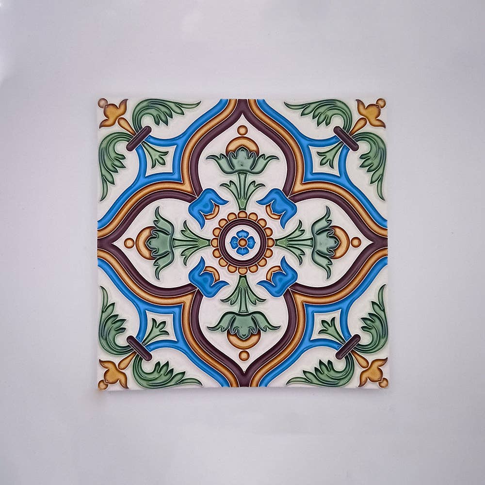 Évora Hand Painted Ceramic Tiles by Tejo Shop feature a symmetrical floral and geometric design in blue, green, yellow, and brown on white—ideal as decorative tiles or a vibrant splashback with leaves, curved lines, and a central circular motif.