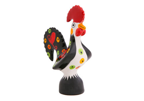 The Love Rooster by Barcelos Imports features a black body, red comb, and vivid yellow, green, and red circles—a classic Portuguese ceramic symbol of good luck—standing upright against a white background.