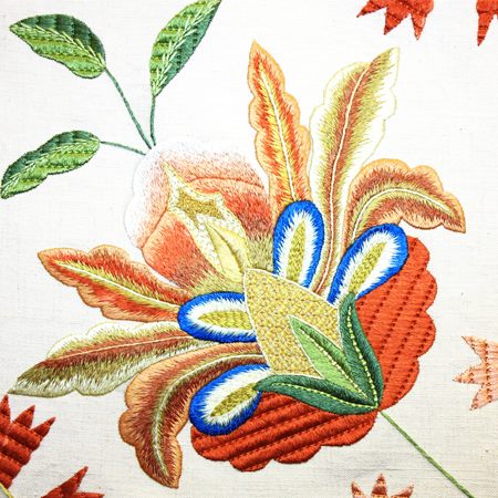 The Terra Lusa Castelo Branco Embroidery Glasses Case features detailed embroidery with yellow, orange, green, and blue threads on natural silk linen, inspired by traditional Portuguese artistry—perfect for a unique handmade accessory.