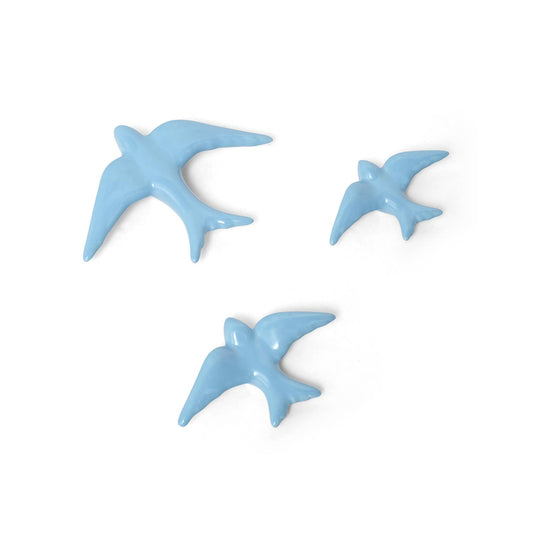 The Casa Atlantica Ceramic Swallows - Set of 3 New Colours features three ceramic swallows in varied sizes, arranged in a flying formation to add Mediterranean charm to your wall decor.