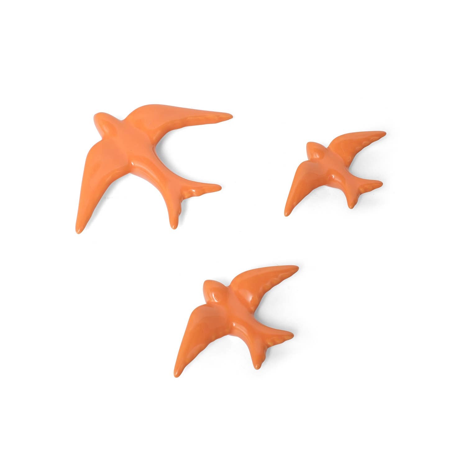 Casa Atlantica’s Ceramic Swallows - Set of 3 New Colours adds Mediterranean charm to your wall decor with three ceramic birds in varied sizes and flying poses, beautifully arranged on a white background.