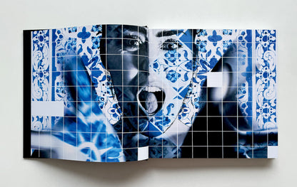 Book with a blue and white patterned cover featuring a face.