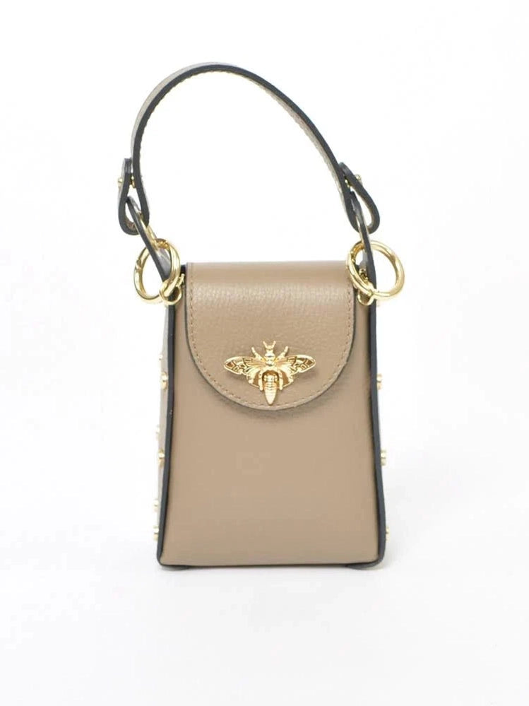 Beige handbag with gold bee emblem on a white background