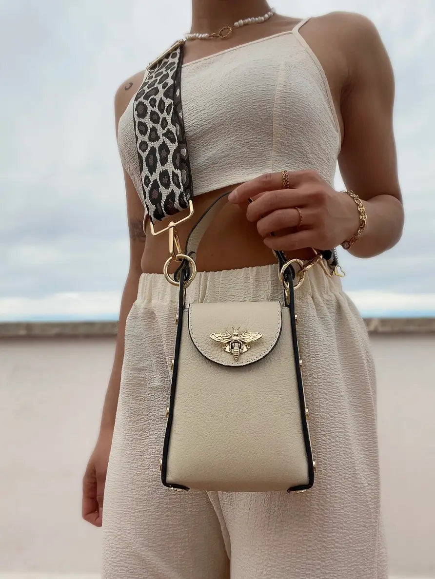 Lifestyle image of Bee bag worn crossbody using Leopard fabric strap.