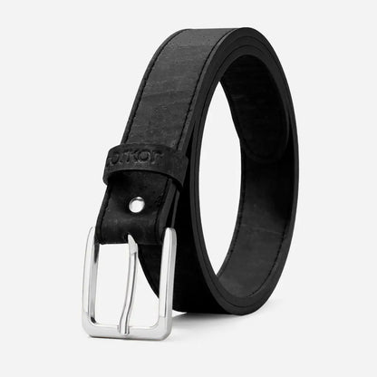 The Corkor Womens Cork Belt – 30mm with Silver Buckle is a black vegan accessory featuring textured cork material and a silver rectangular buckle, shown coiled upright against a plain light background.