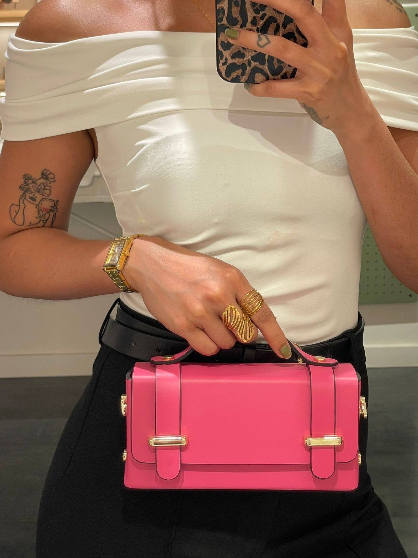 Lifestyle photo of the Carmel genuine leather bag in Pink being held by a model, showing size and top-handle detail.