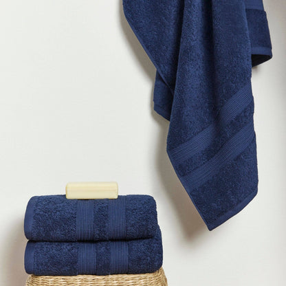 Stack of cobalt blue Portuguese towels neatly folded.