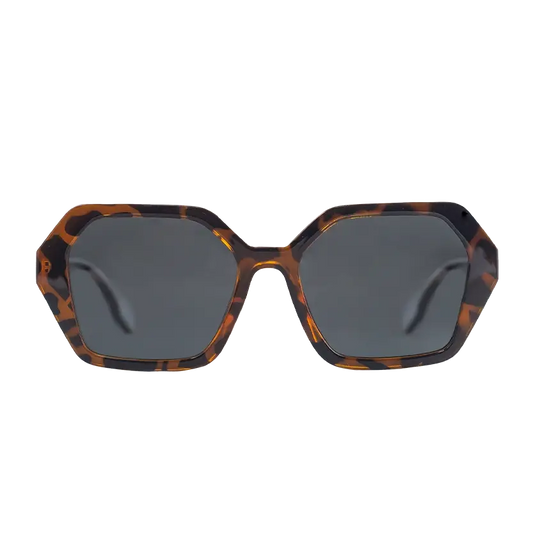 The Oceanides Coral Dark Havana Sunglasses feature an oversized geometric design with a tortoiseshell brown and black acetate frame and dark grey polarized lenses, shown front-facing against a white background.