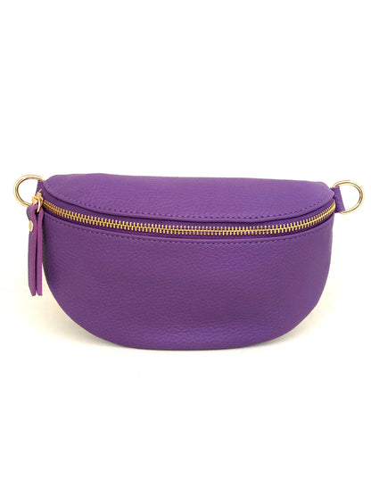 Cassette fanny pack/crossbody in Purple Italian leather with gold zip and matching strap, front view on white.