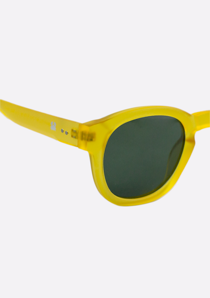 Close-up of Oceanides Atlas Yellow Frosted Sunglasses featuring dark oval polarized lenses and a recycled plastic frame, set against a plain white background.