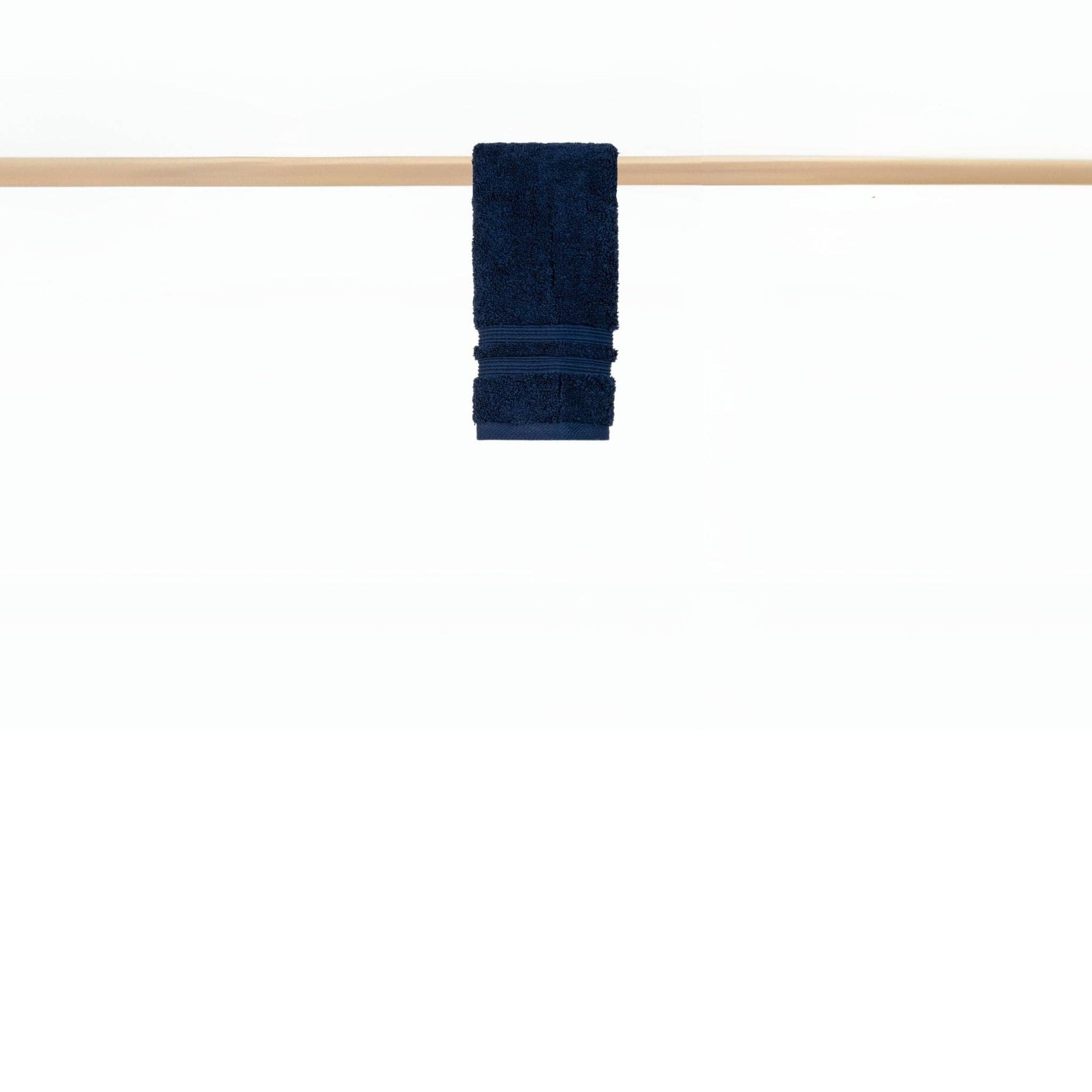 : Cobalt blue hand towel hanging on rail in a modern bathroom