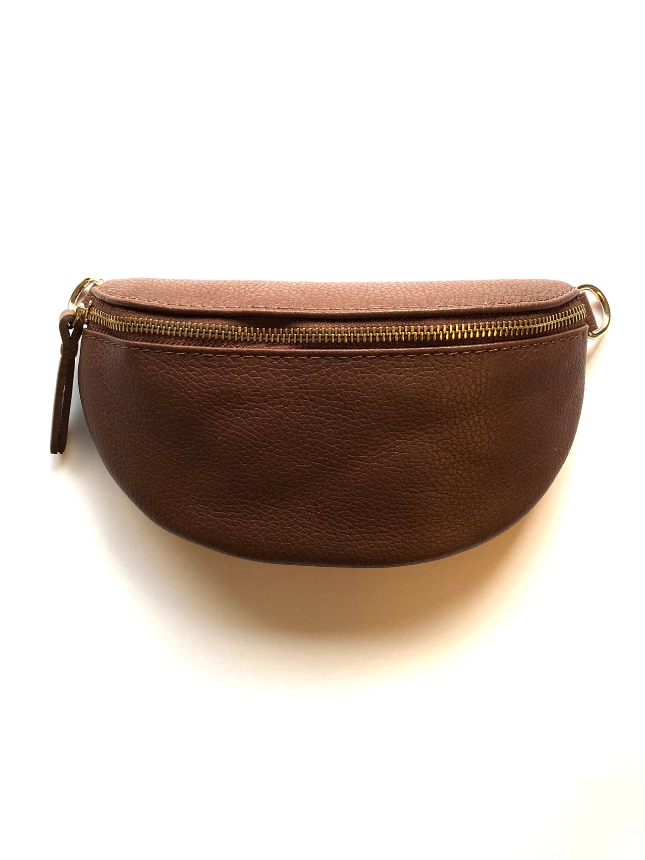 The Cassette Barcelona Leather Fanny Pack Crossbody Bag is a brown premium leather pouch with a curved shape, zip closure, leather pull tab, and metal rings—ideal as a stylish crossbody or fanny pack. Shown on a white background.