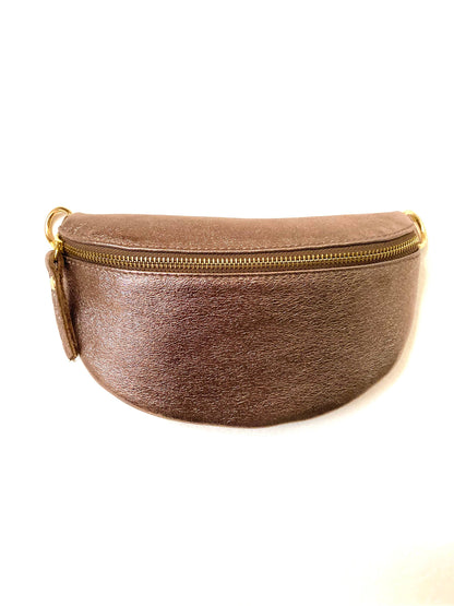 The Cassette Barcelona Metallic Leather Fanny Pack Crossbody Bag features a gold zipper and side loop, shown against a white background.