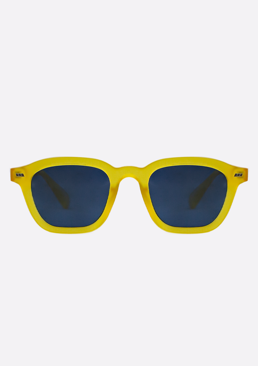 The Oceanides Neda Yellow Frosted Sunglasses feature geometric frames crafted from recycled plastic and dark blue lenses, shown against a plain white background.