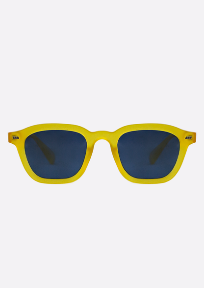The Oceanides Neda Yellow Frosted Sunglasses feature geometric frames crafted from recycled plastic and dark blue lenses, shown against a plain white background.