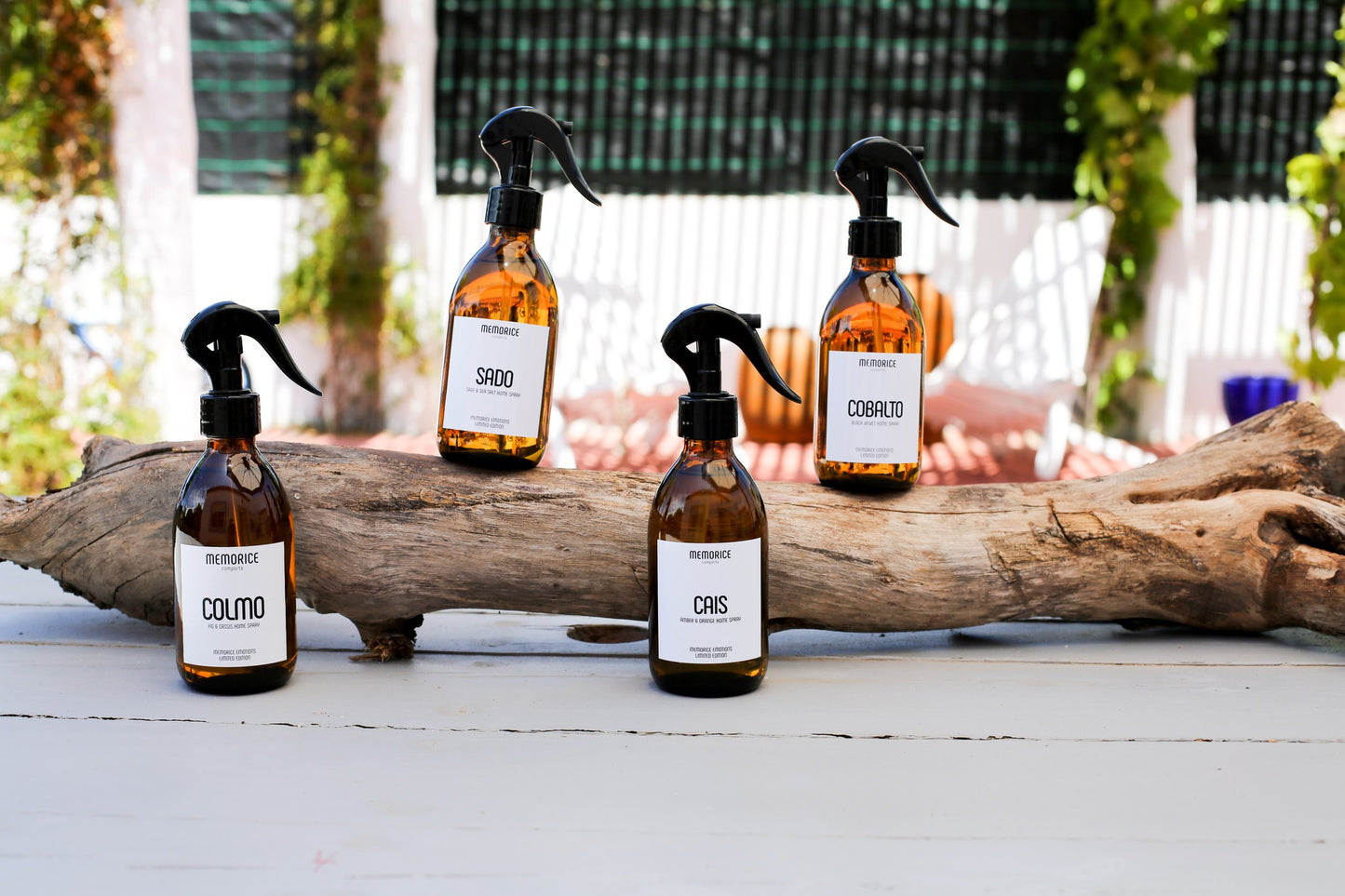 Amber room spray bottles on a wooden branch