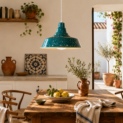 Handcrafted teal speckled enamel pendant light hanging above a rustic timber dining table in a minimalist Portuguese-inspired kitchen with warm Mediterranean styling.
