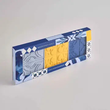 The Manulena Portuguese Azulejo Scented Magnet Set – Set of 3 includes rectangular magnets with gray, yellow, and blue geometric and tile-inspired embossed patterns, reminiscent of traditional Portuguese azulejo designs.