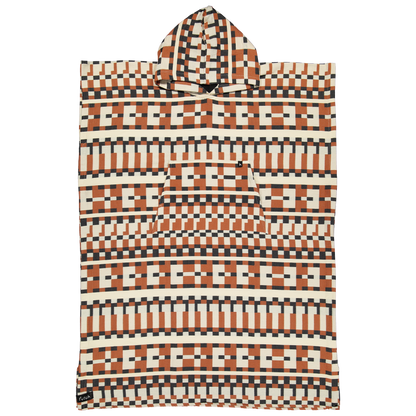 The Cacela Poncho by Futah is a hooded beach poncho towel featuring a geometric pattern with brown, black, and cream tones. Inspired by Portuguese beachwear, its design showcases repeating zigzags and rectangular shapes, complemented by a large front pocket.