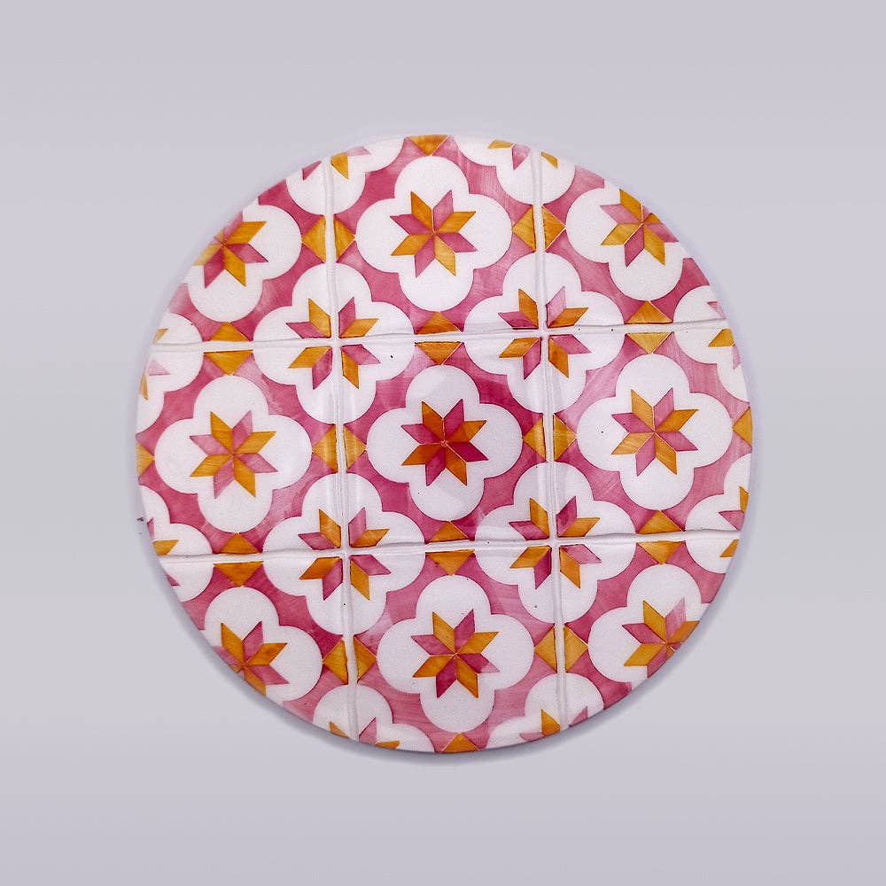 ceramic trivet with red and yellow motif