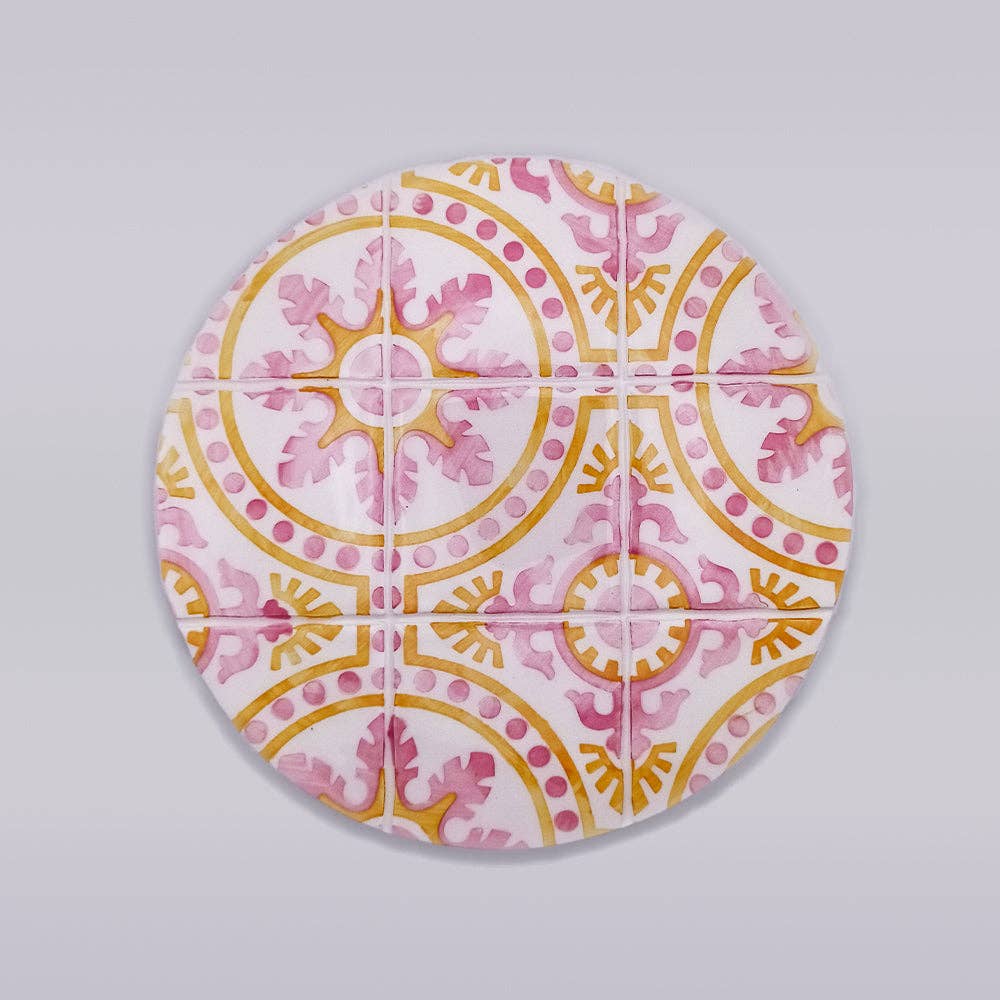 ceramic trivet with pink and yellow motif