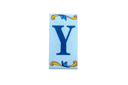 Lisa Croquets Letters – Ceramic House Letter Tile featuring a blue letter Y with decorative yellow and blue scrolls at the top and bottom.