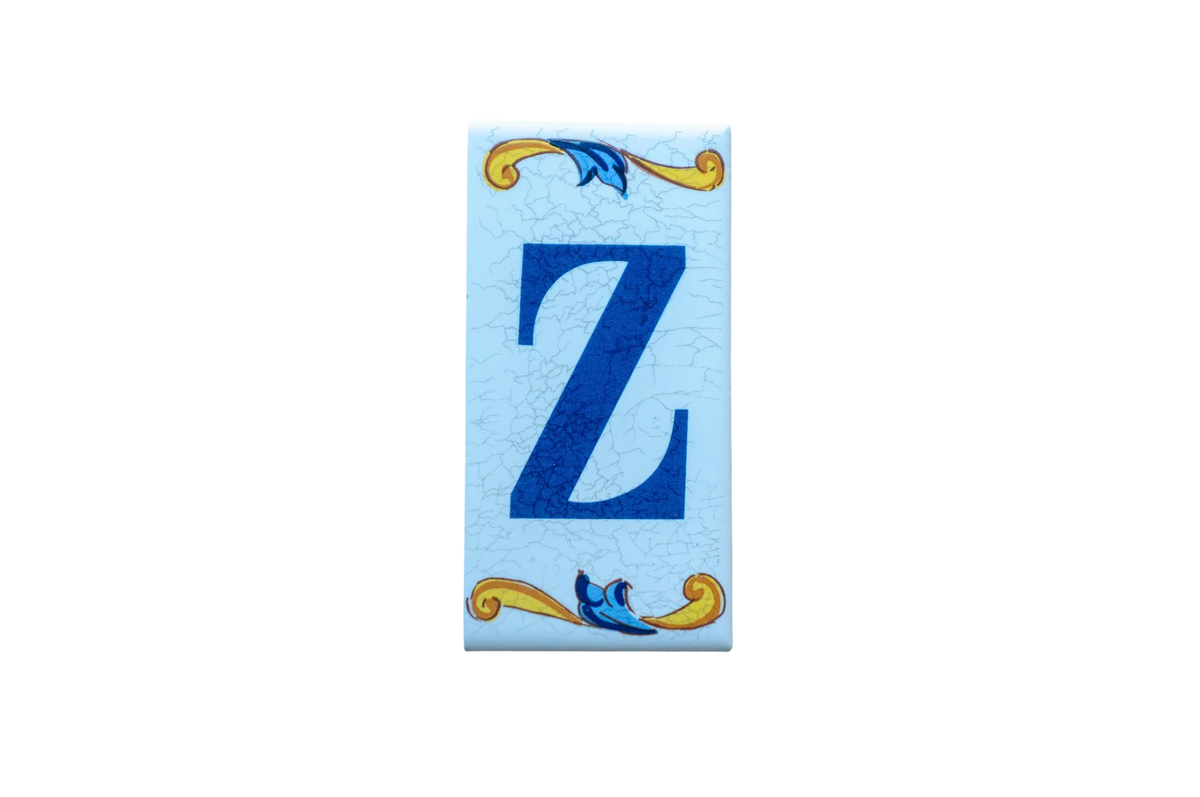 Lisa Croquets Letters – Ceramic House Letter Tiles featuring a dark blue letter Z on a light blue background, accented with yellow and blue scrollwork at the top and bottom.