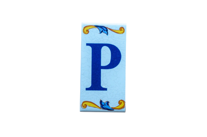 Lisa Croquets Letters – Ceramic House Letter Tiles featuring a blue letter P with blue and gold decorative flourishes at the top and bottom.