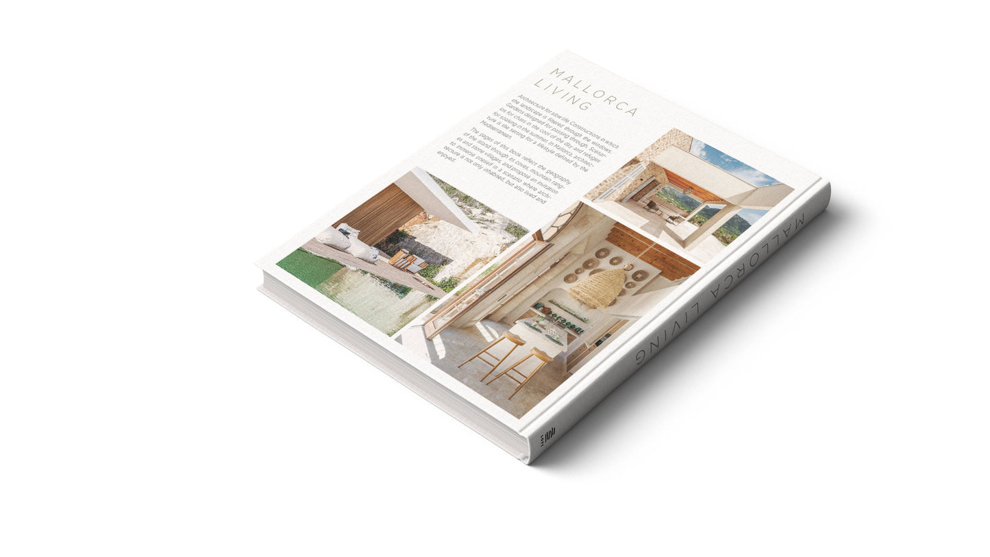 Mallorca Living by Loft Publications, a hardcover coffee table book featuring images of modern Mediterranean interiors and exteriors with light neutral colors and natural materials, is displayed on a white surface.