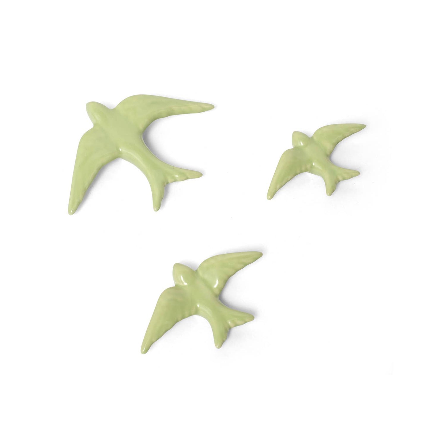 The Casa Atlantica Ceramic Swallows - Set of 3 New Colours features charming ceramic swallows in varying sizes, arranged as if in flight, perfect for adding a touch of Mediterranean style to your wall decor.