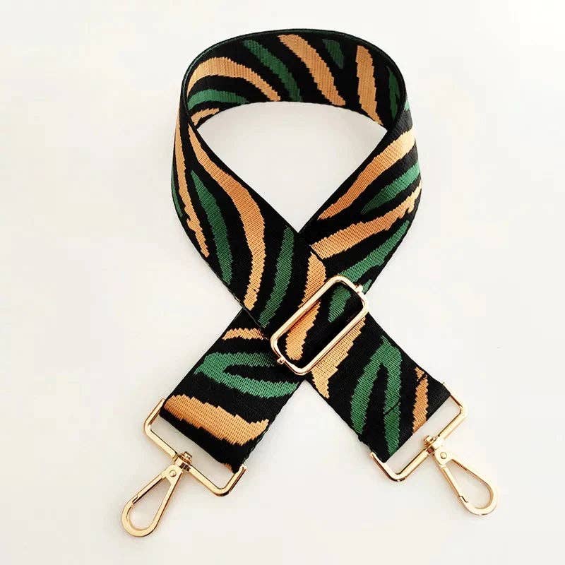 Full-length flat lay of green and gold zebra strap with gold hooks, designed in Barcelona