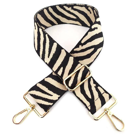 Zebra bag strap in black and creamy white with gold hooks, front view on white, adjustable 60–130 cm.