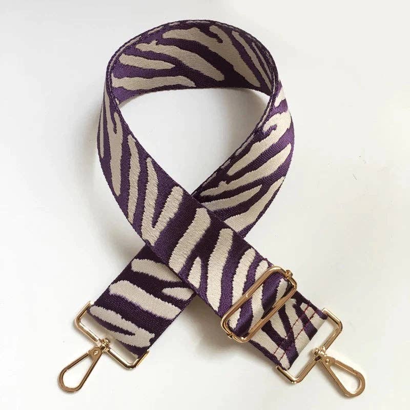 Zebra bag strap in purple and cream, front view on a white background.
