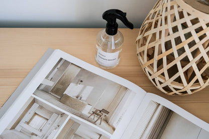 Comporta Daylight Home Spray bottle next to open interior design magazine