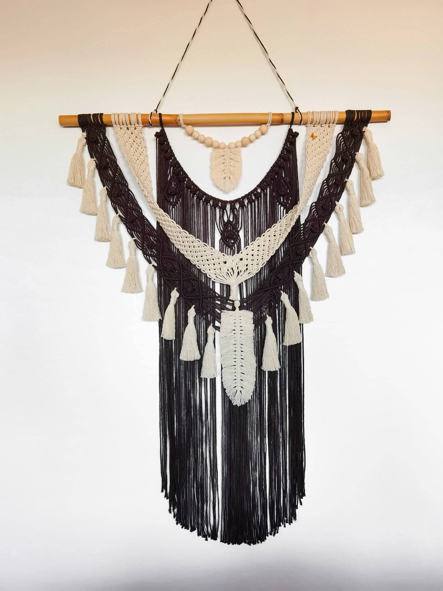 Macrame wall hanging with feathers and tassels