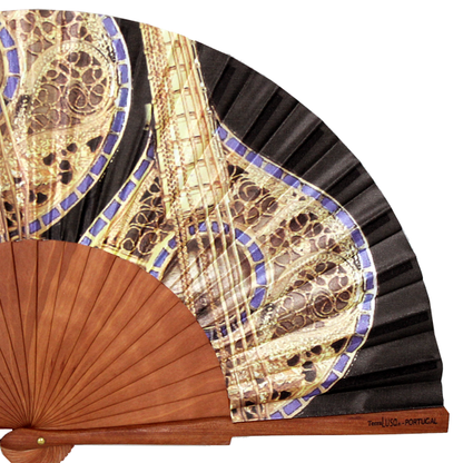 Close up of a hand fan with a Portuguese guitar design 