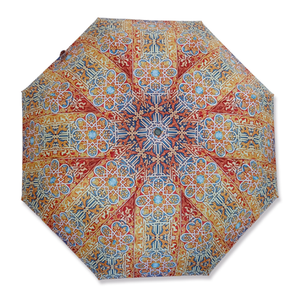 An open umbrella with a stained glass print