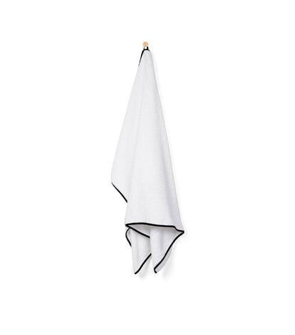 Black Mira bath towel hanging on a hook