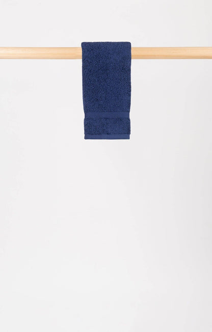 cobalt blue almonda hand towel hanging on a wooden rail