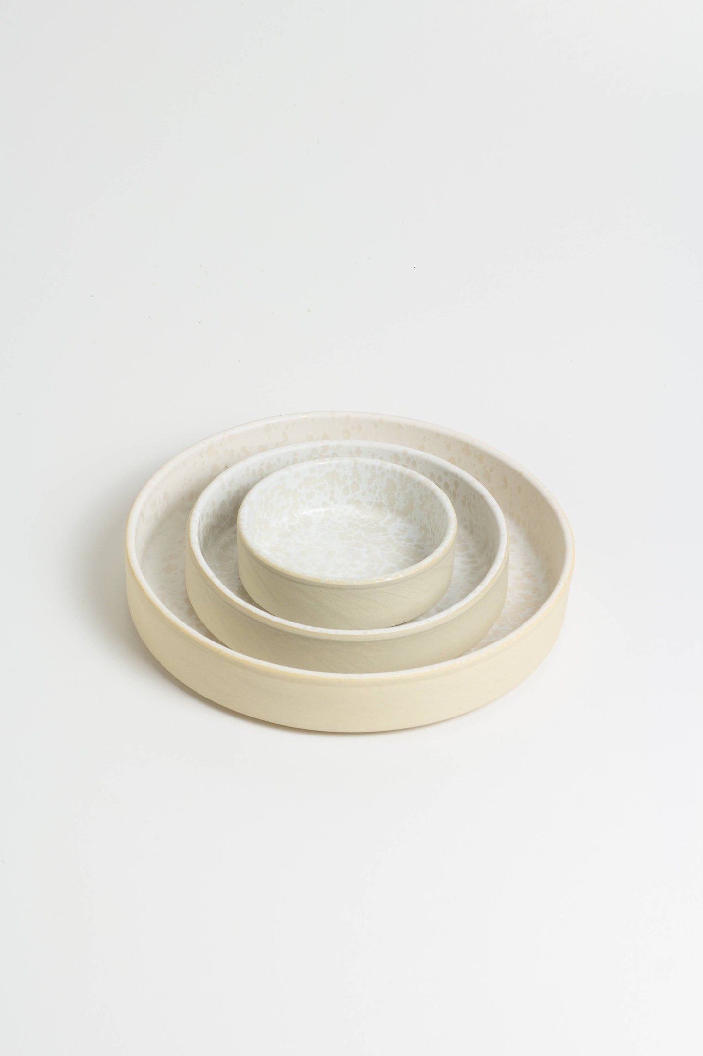 set of round beige ceramic plates