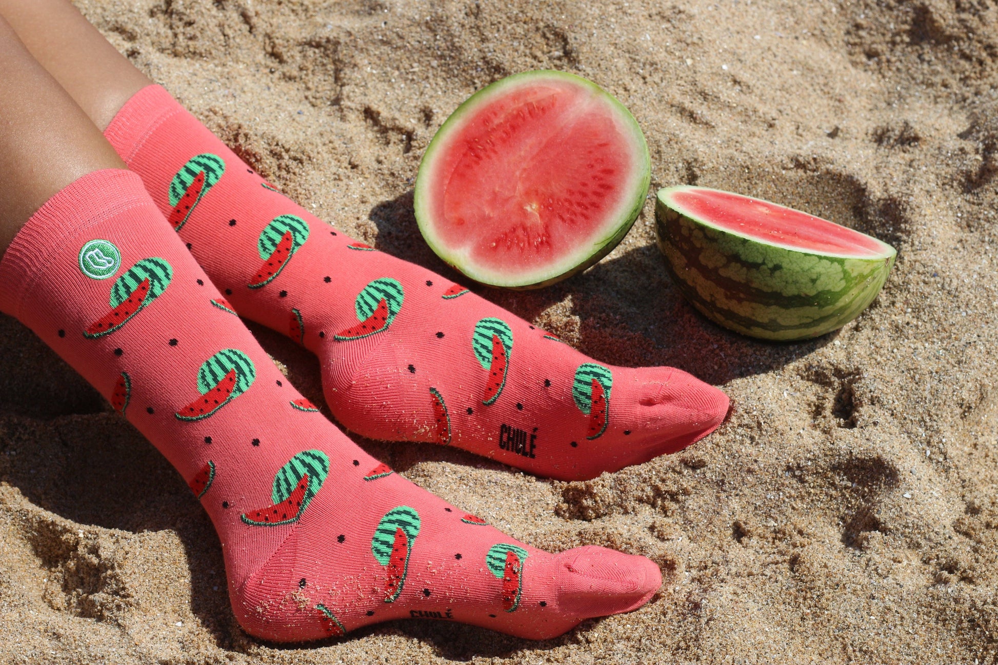 Female wearing a pair of watermelon socks on the beach